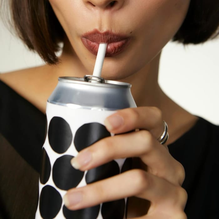 A guest sipping from a spotted can