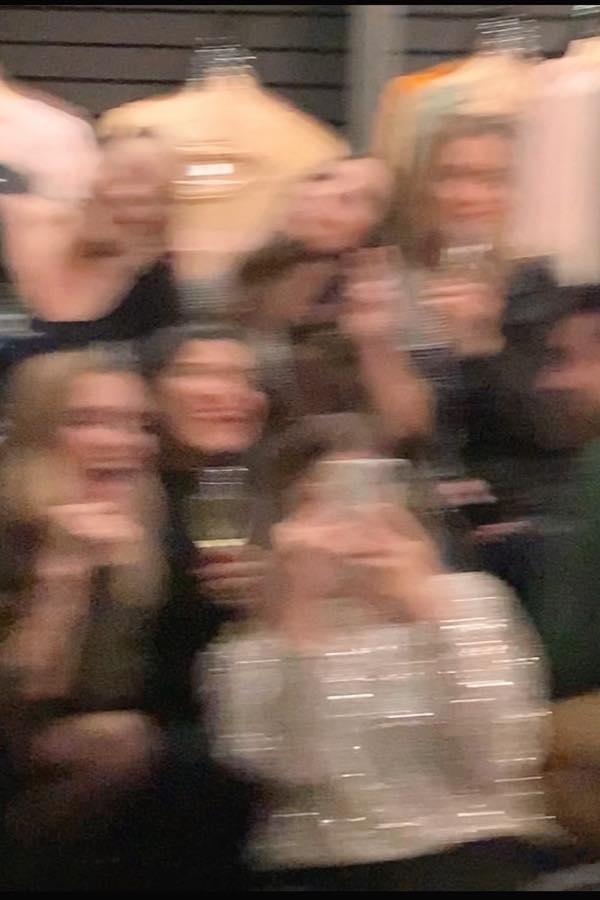 Guests talking in a small room at a listening party