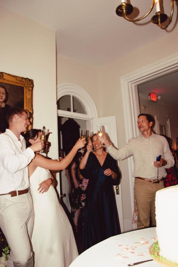 Guests talking in a small room at a listening party
