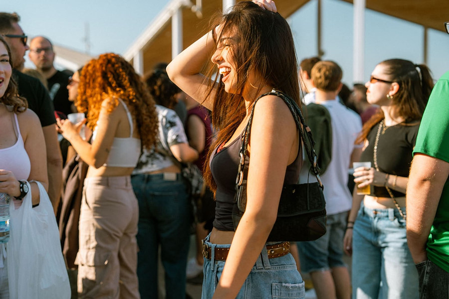 Guests laughing on a rooftop in the sun