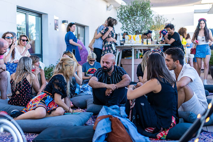 Guests relaxing on rooftop cushions